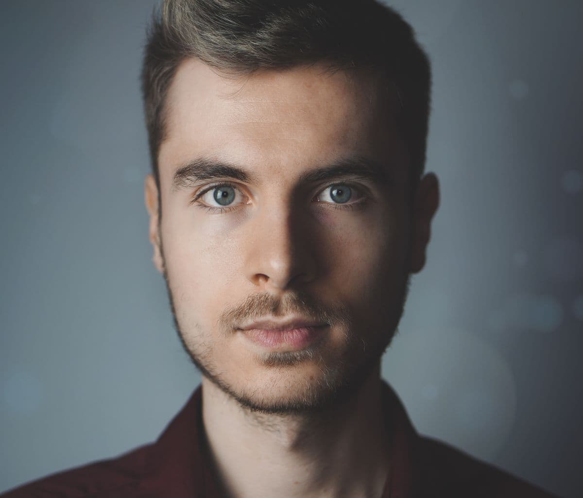 Studio headshot of a man with even professional lighting